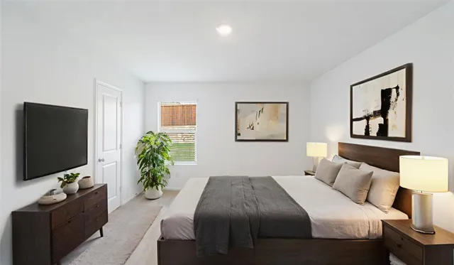 a bedroom with a bed and a flat screen tv