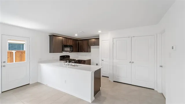 a kitchen with a sink a counter top space and cabinets