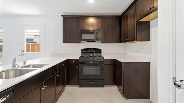 a kitchen with a sink and a stove