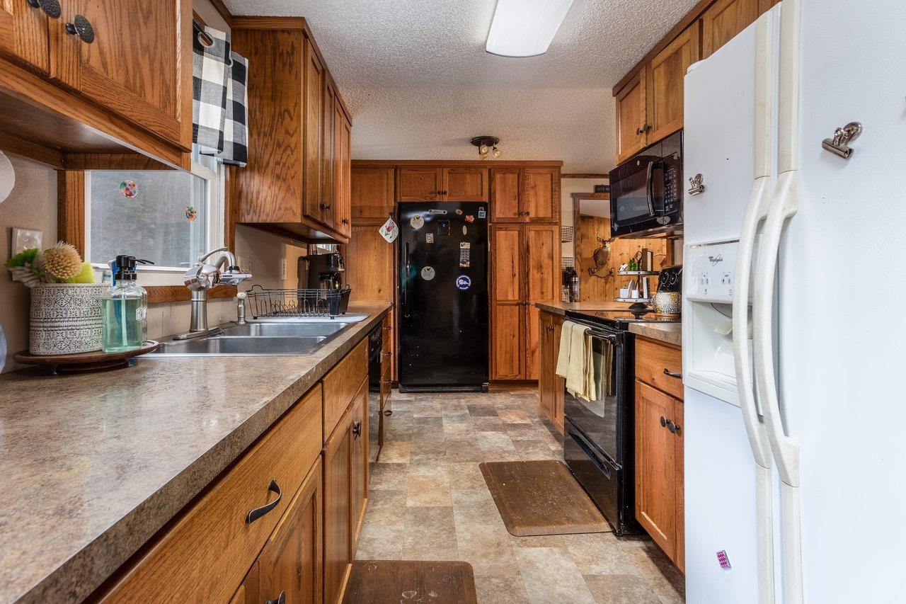 8448 Briery Branch Road Dayton, VA 22821 - Photo 11 of 37 a kitchen with stainless steel appliances granite countertop a refrigerator and a sink