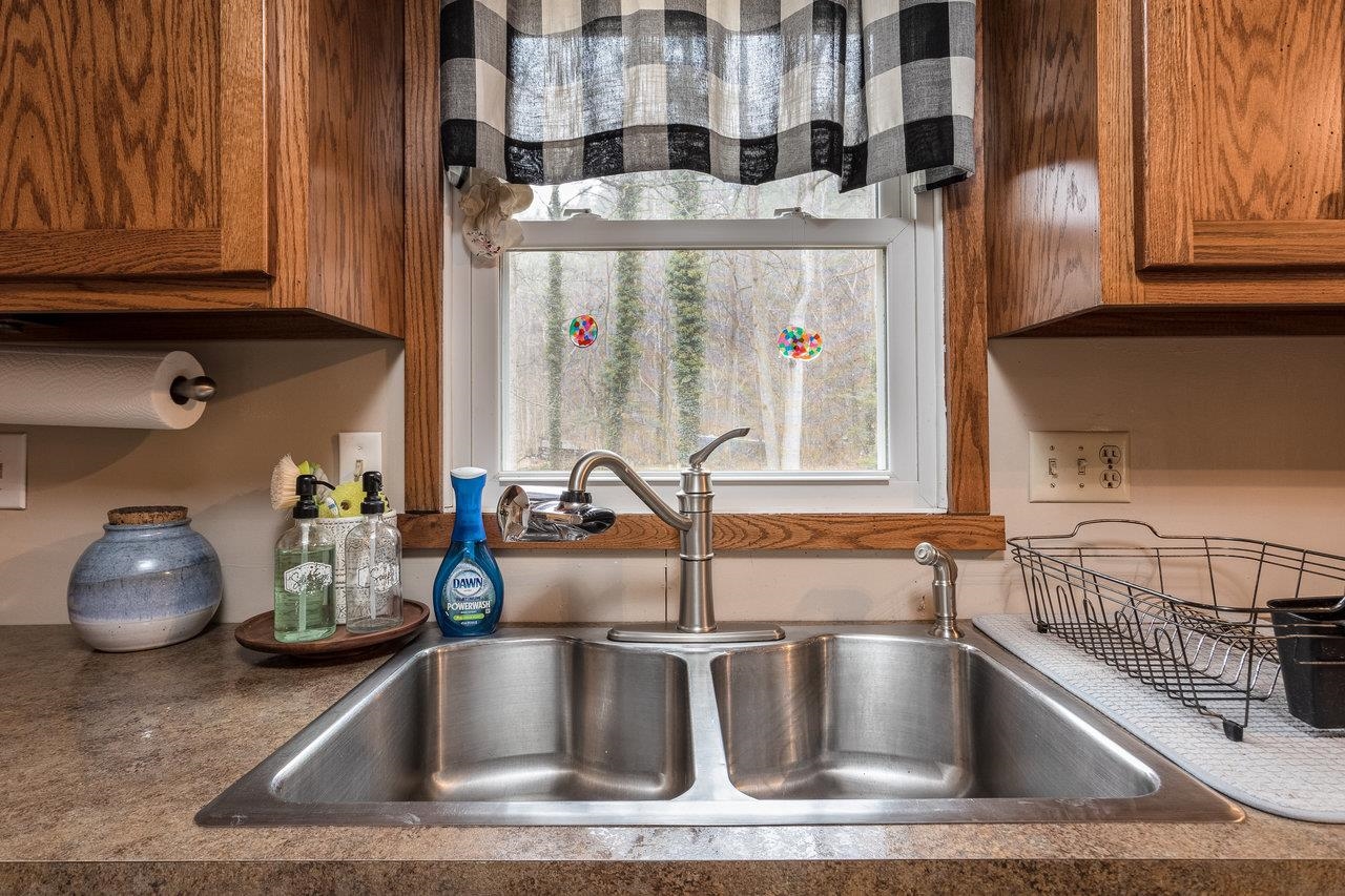 8448 Briery Branch Road Dayton, VA 22821 - Photo 13 of 37 a kitchen with a sink cabinets and a window