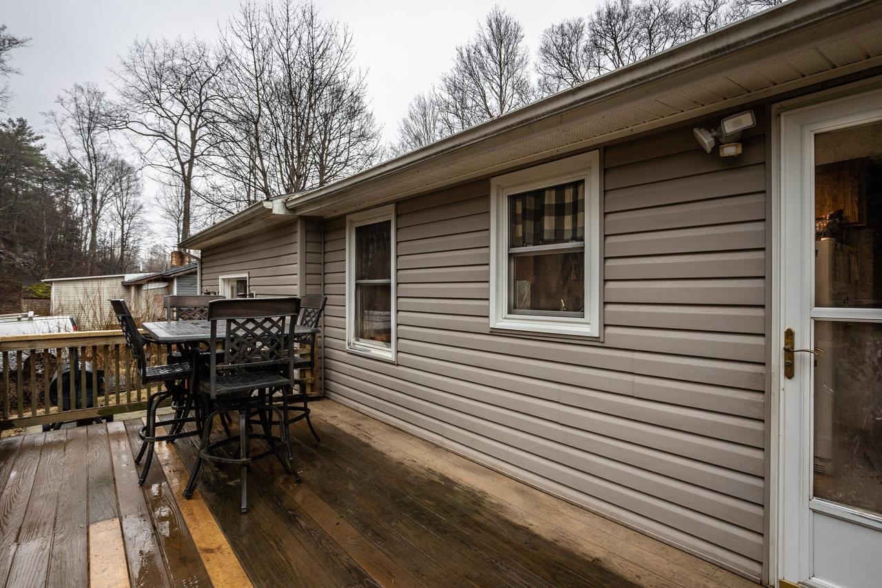 8448 Briery Branch Road Dayton, VA 22821 - Photo 35 of 37 a roof deck with table and chairs and wooden floor