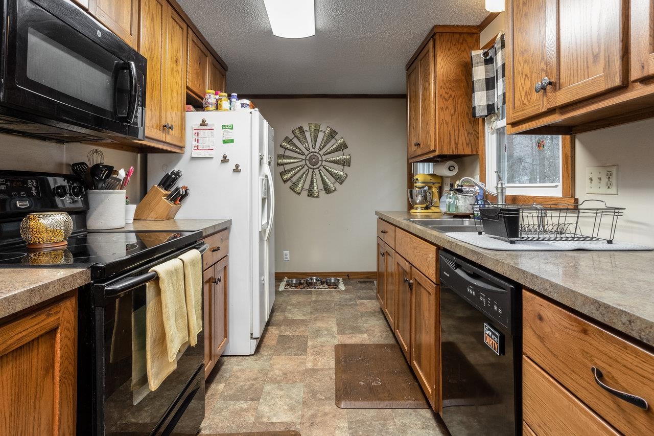 8448 Briery Branch Road Dayton, VA 22821 - Photo 9 of 37 a kitchen with stainless steel appliances granite countertop a sink stove and refrigerator
