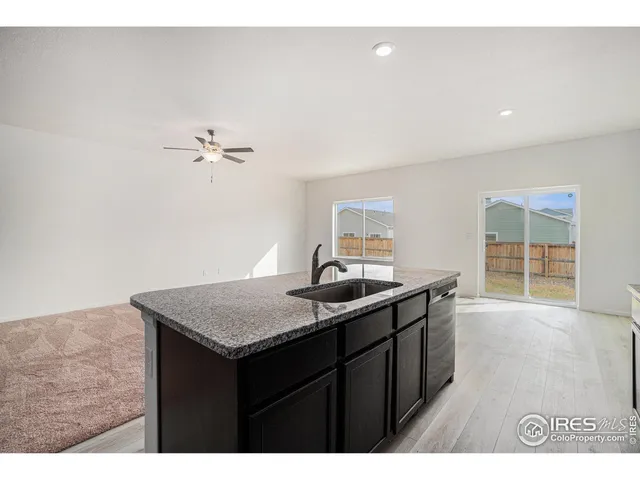 a kitchen with a sink cabinets and wooden floor