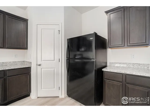 a kitchen with a refrigerator and cabinets