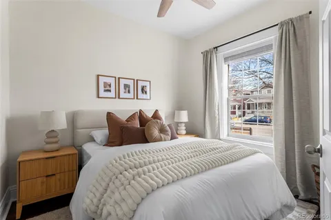 a bedroom with a large bed and a window