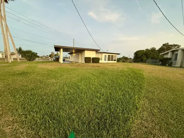 a big room with yard and pool table under an umbrella