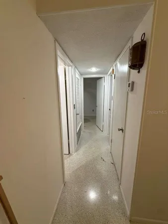a view of a hallway with a refrigerator