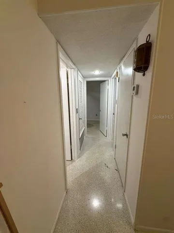 a view of a hallway with a refrigerator