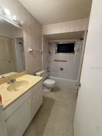 a spacious bathroom with a sink a toilet and shower