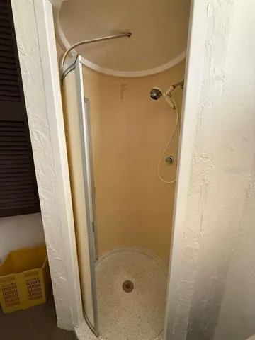 a bathroom with a glass door shower and a sink
