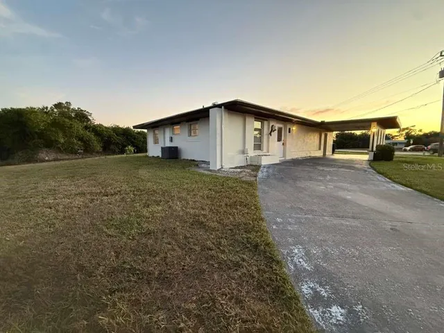 a big house with a big yard and large trees