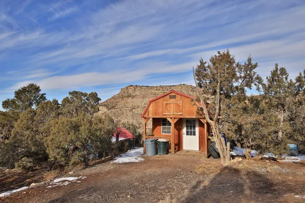 a view of a big house with a mountain in the background