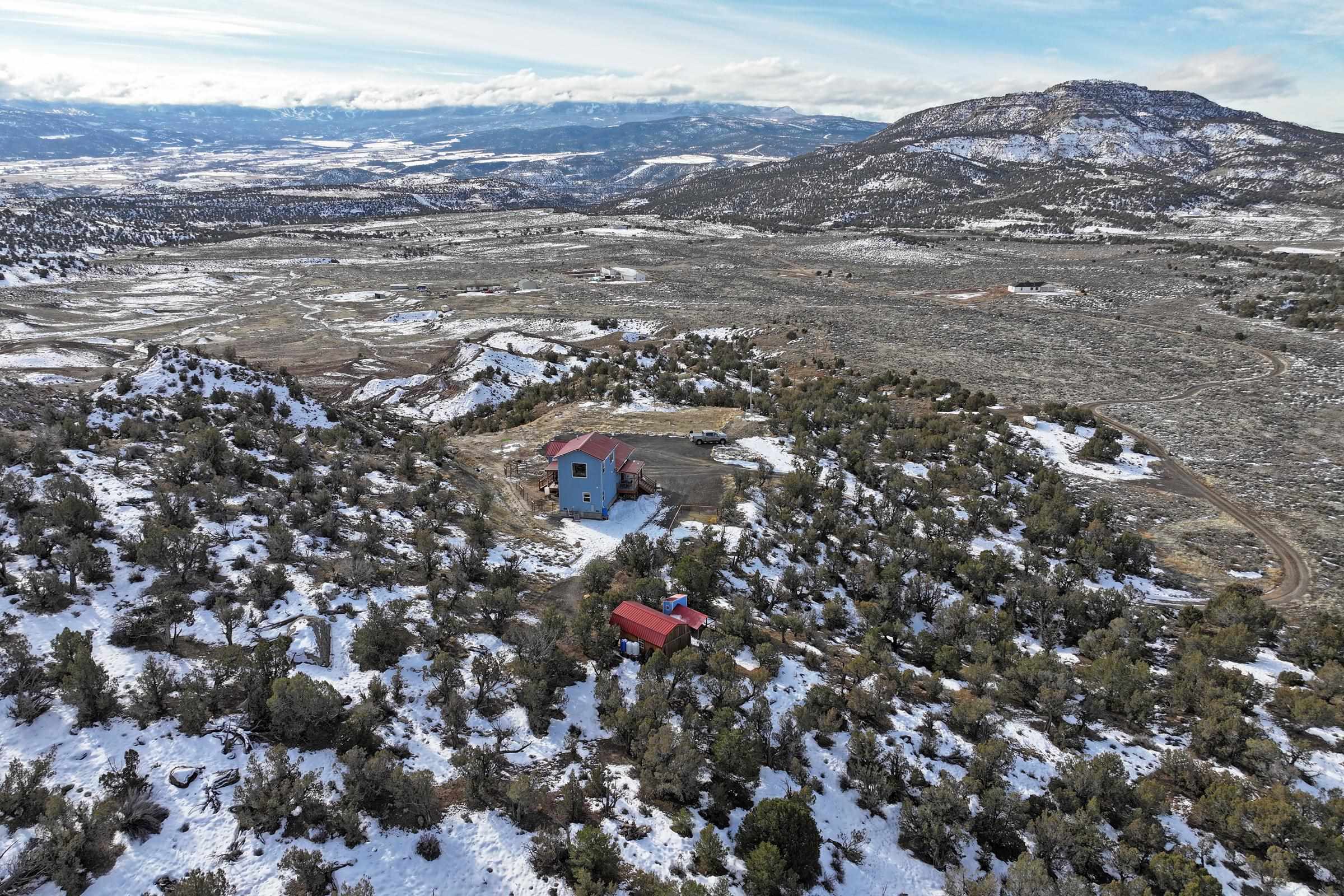 15086-45 45 1/2 Road De Beque, CO 81630 - Photo 23 of 40 an aerial view of house with yard and mountain view in back