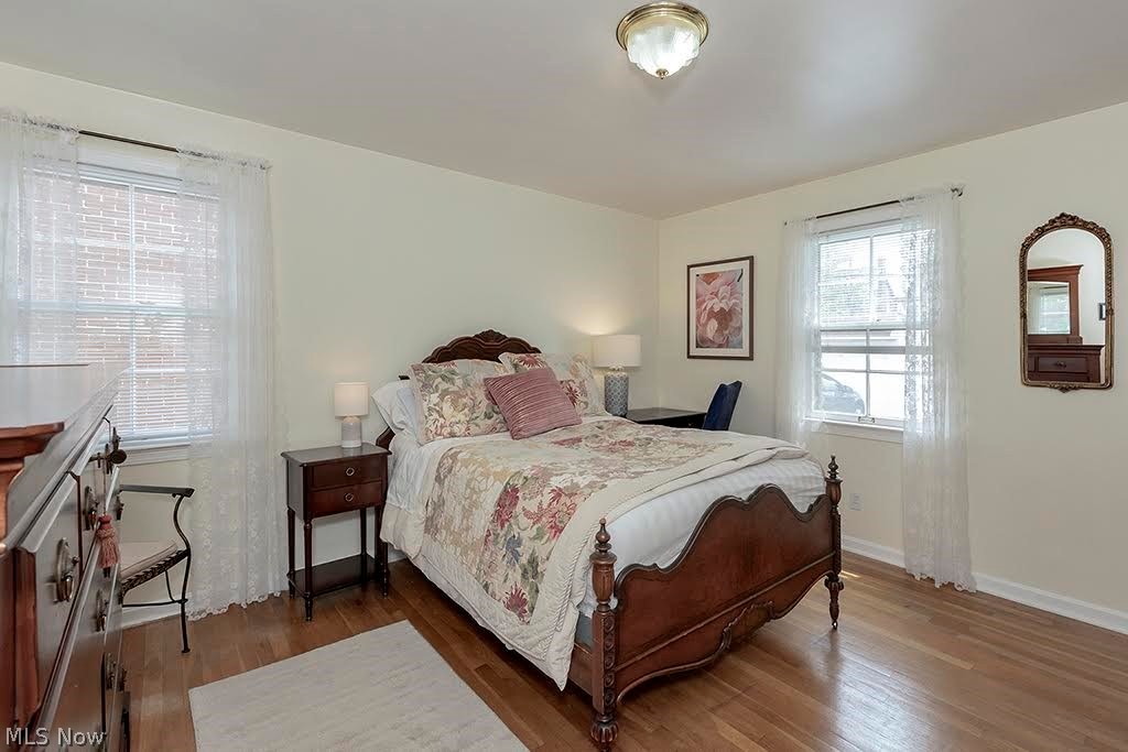 13582 Cedar Road Cleveland, OH 44118 - Photo 14 of 42 Primary Bedroom featuring 2 windows, closet and hardwood floors