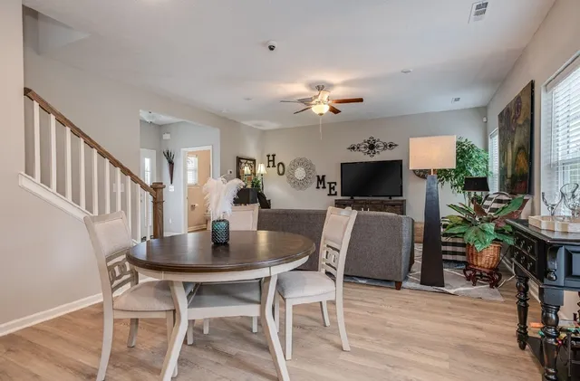 a view of a dining room with furniture and wooden floor