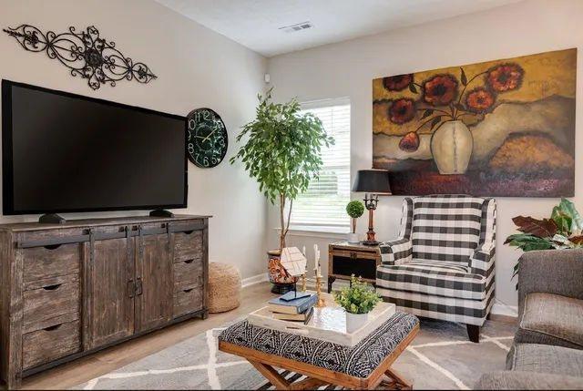 a living room with furniture and a flat screen tv
