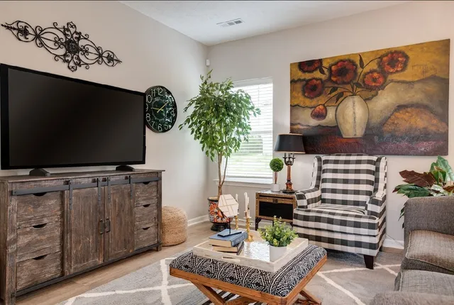 a living room with furniture and a flat screen tv
