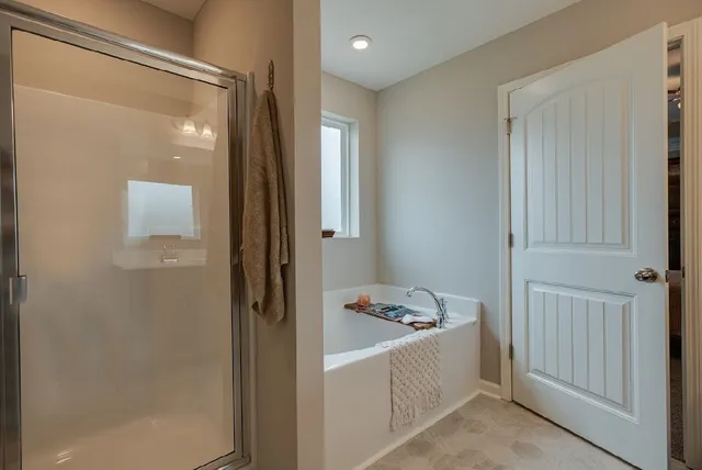 a bathroom with a tub and shower