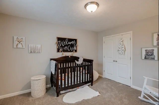 a bedroom with a white bed and a window