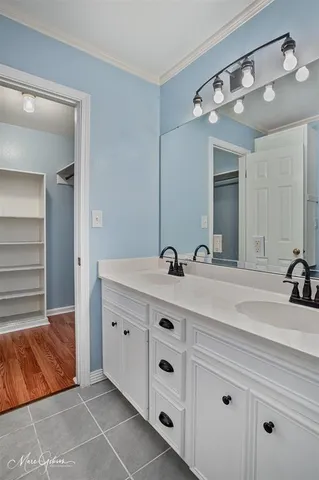 a bathroom with a double vanity sink and a mirror