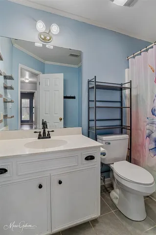 a bathroom with a sink a toilet a mirror and shower