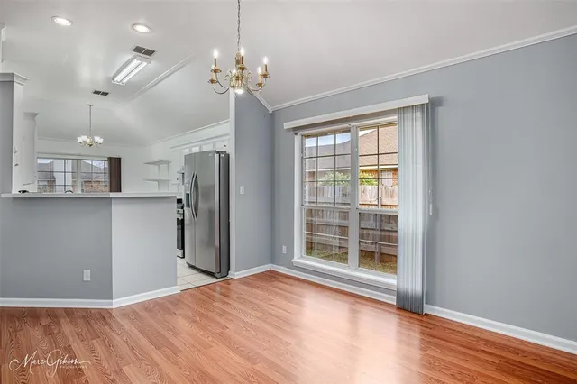 a view of a room with a windows and wooden floor