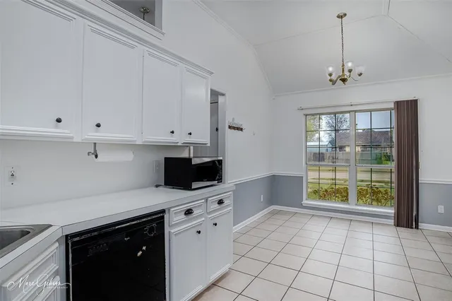 a kitchen with stainless steel appliances granite countertop a stove a sink and a white cabinets