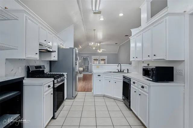 a kitchen with stainless steel appliances a stove sink and refrigerator