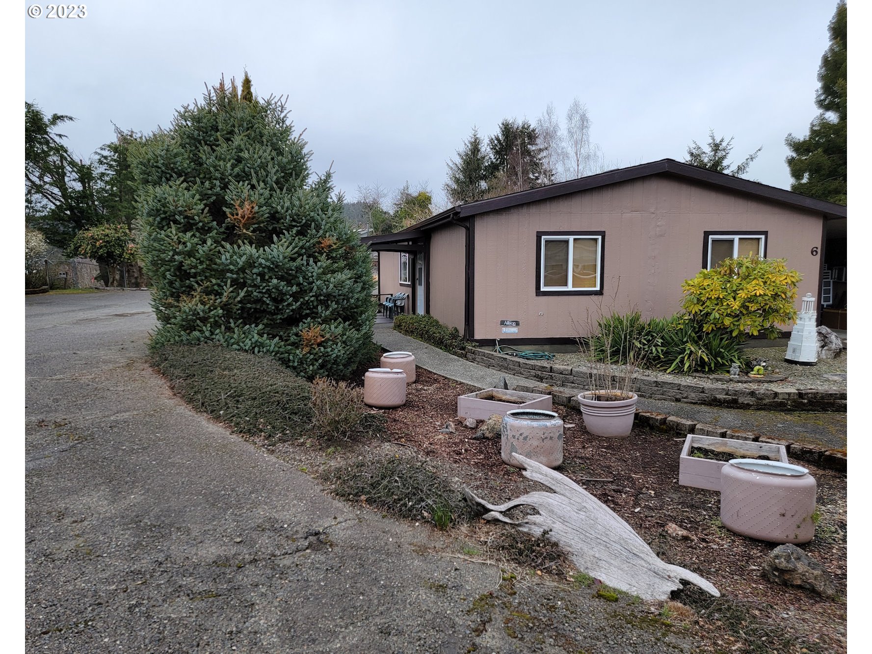 100 River Bend Road, Unit 6 Reedsport, OR 97467 - Photo 2 of 26 a view of back yard of the house