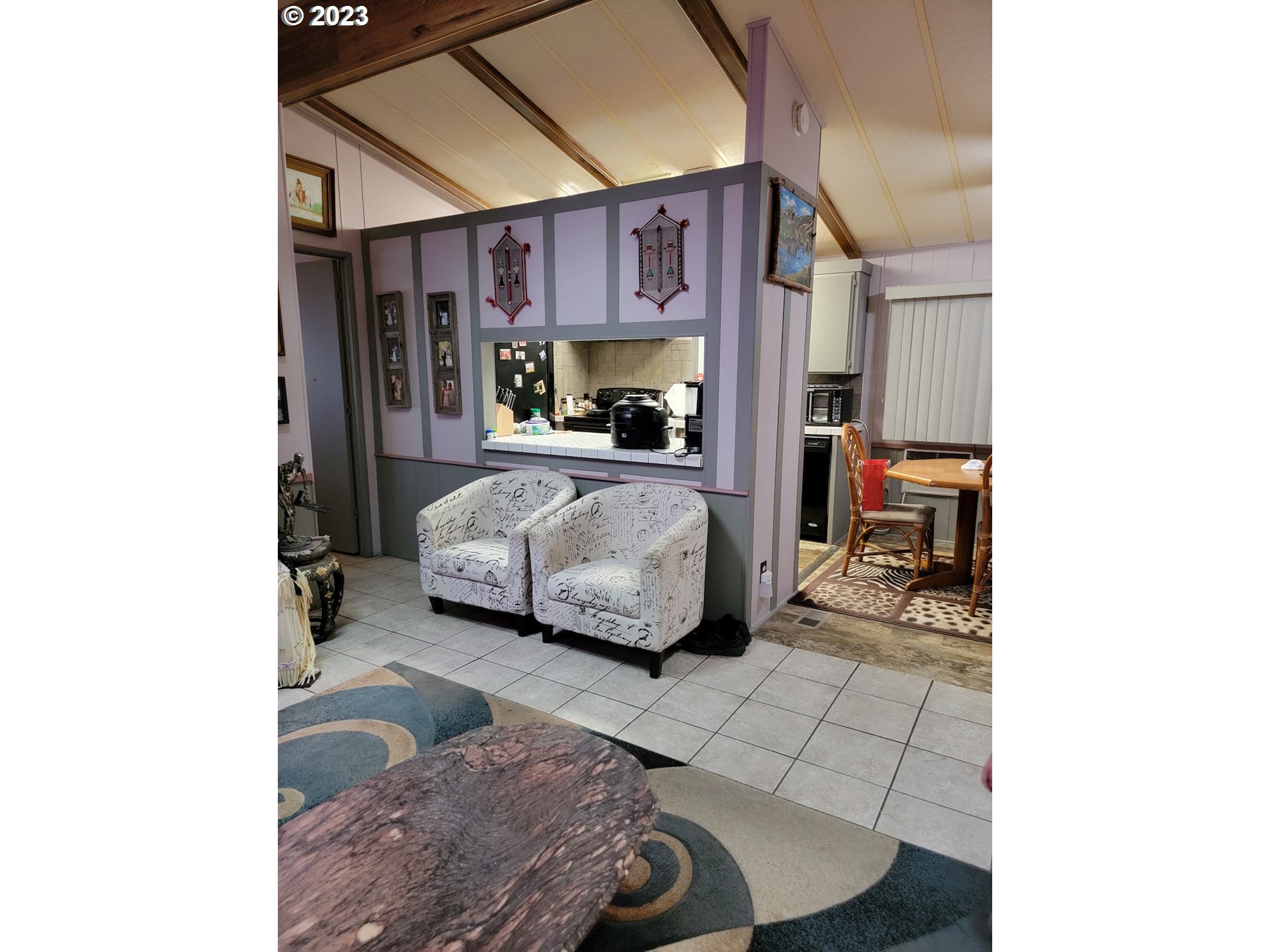 100 River Bend Road, Unit 6 Reedsport, OR 97467 - Photo 6 of 26 a bed room with a bed and a chair