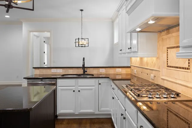 an empty room with a fireplace and wooden floor