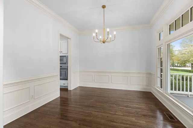 a kitchen with granite countertop white cabinets and a stove