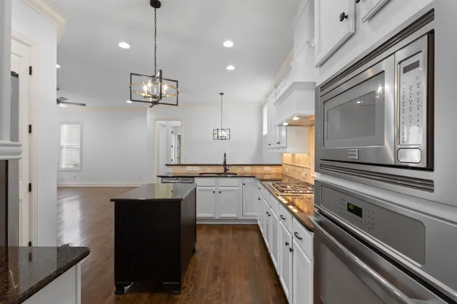 a kitchen with a sink stove and cabinets