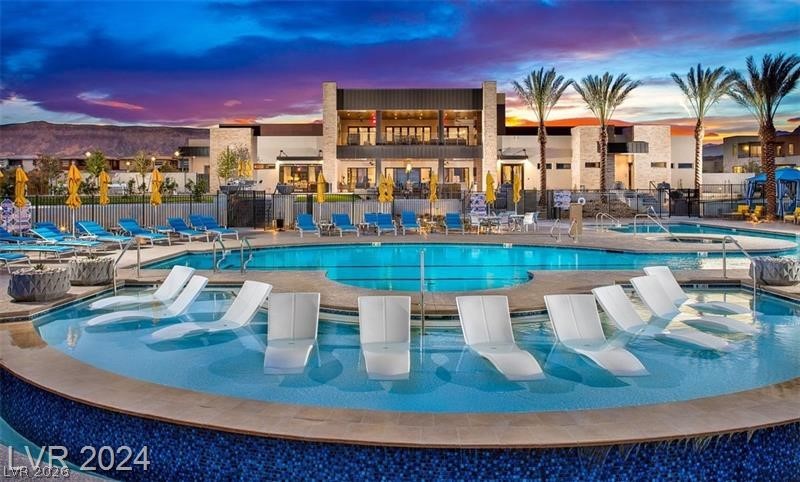 4246 Swift Street Las Vegas, NV 89135 - Photo 60 of 71 Pool at dusk with a community pool, a patio area, and a community hot tub