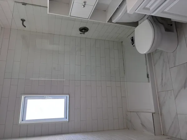 a bathroom with a shower and a window