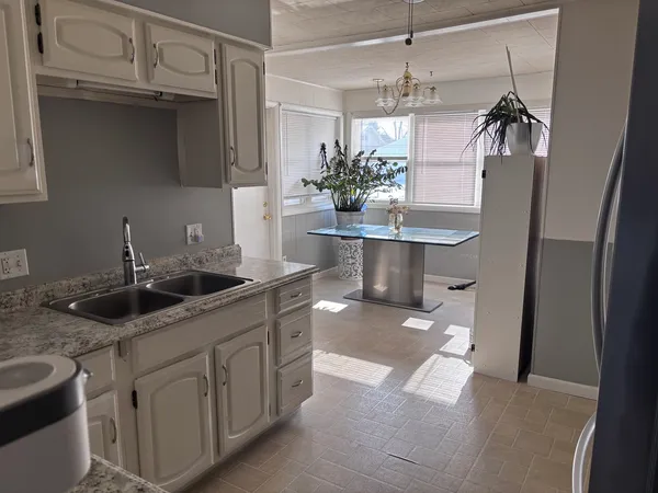 a kitchen with a sink and refrigerator