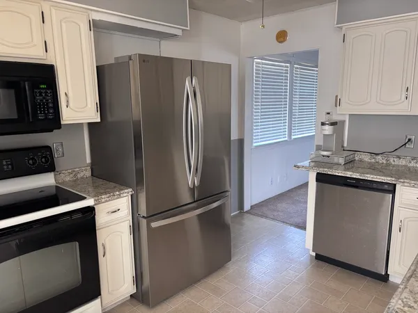 a kitchen with a refrigerator stove and microwave
