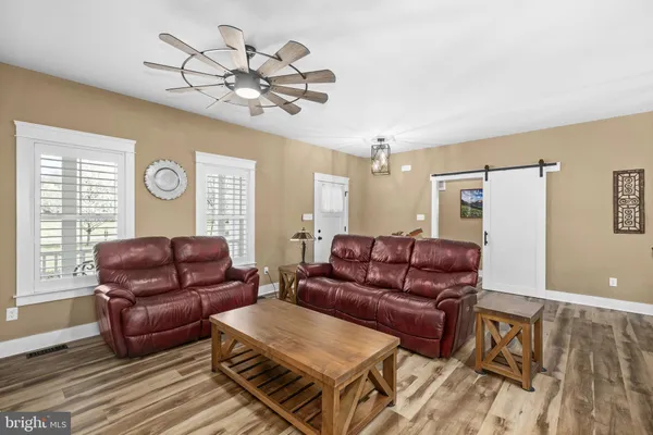 a kitchen with stainless steel appliances granite countertop a stove top oven a refrigerator a sink and a chandelier