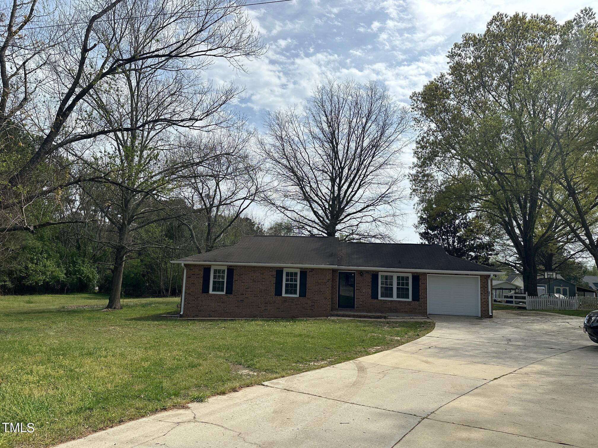 3309 Banks Road Raleigh, NC 27603 - Photo 2 of 11 a front view of a house with a garden and trees