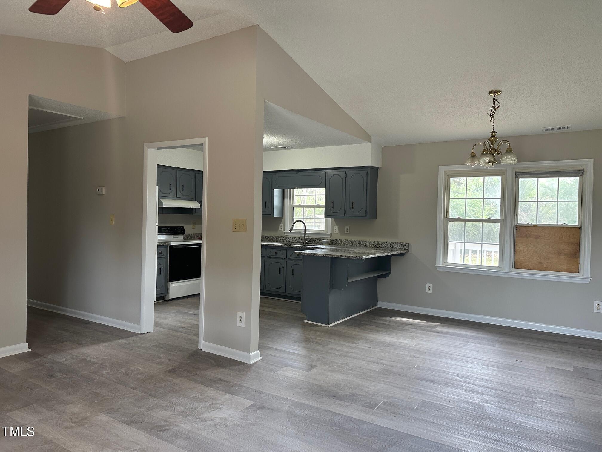 3309 Banks Road Raleigh, NC 27603 - Photo 6 of 11 an empty room with kitchen and a window
