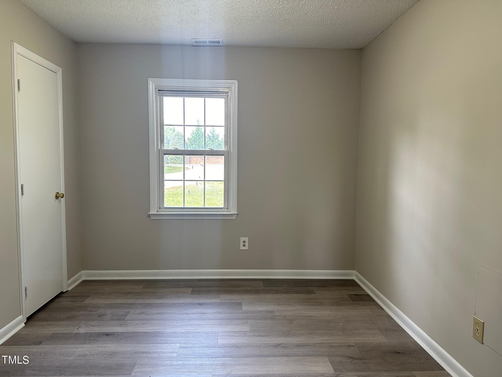 3309 Banks Road Raleigh, NC 27603 - Photo 10 of 11 a view of a room with wooden floors and window