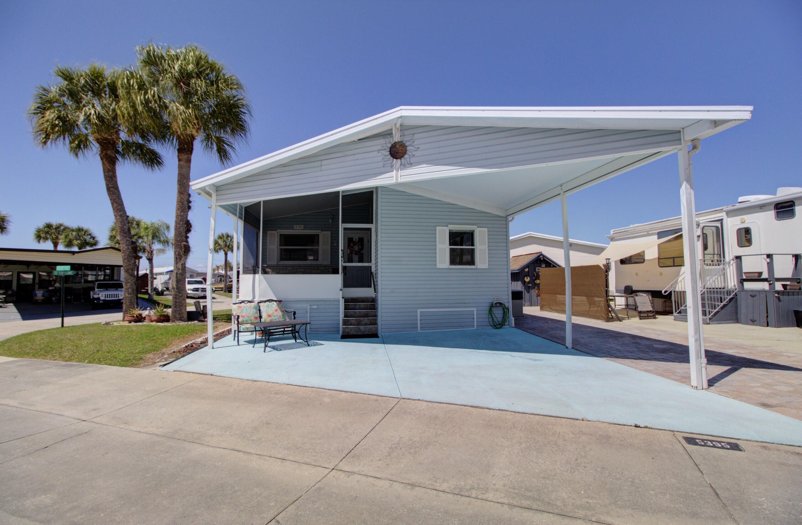 5395 Southeast 64th Terrace Okeechobee, FL 34974 - Photo 1 of 24 a view of a house with backyard and a garden