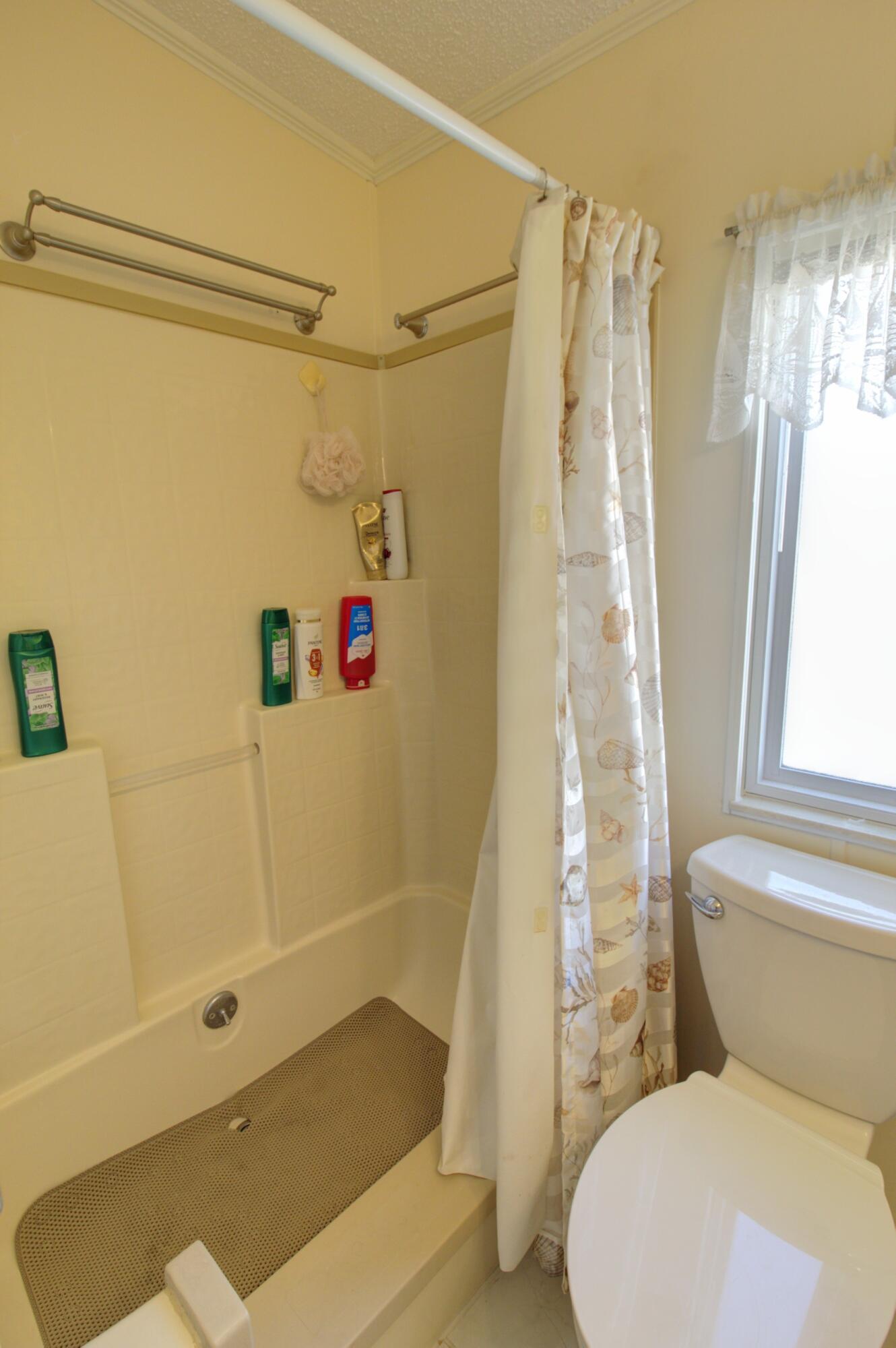 5395 Southeast 64th Terrace Okeechobee, FL 34974 - Photo 14 of 24 a bathroom with a shower curtain and a sink
