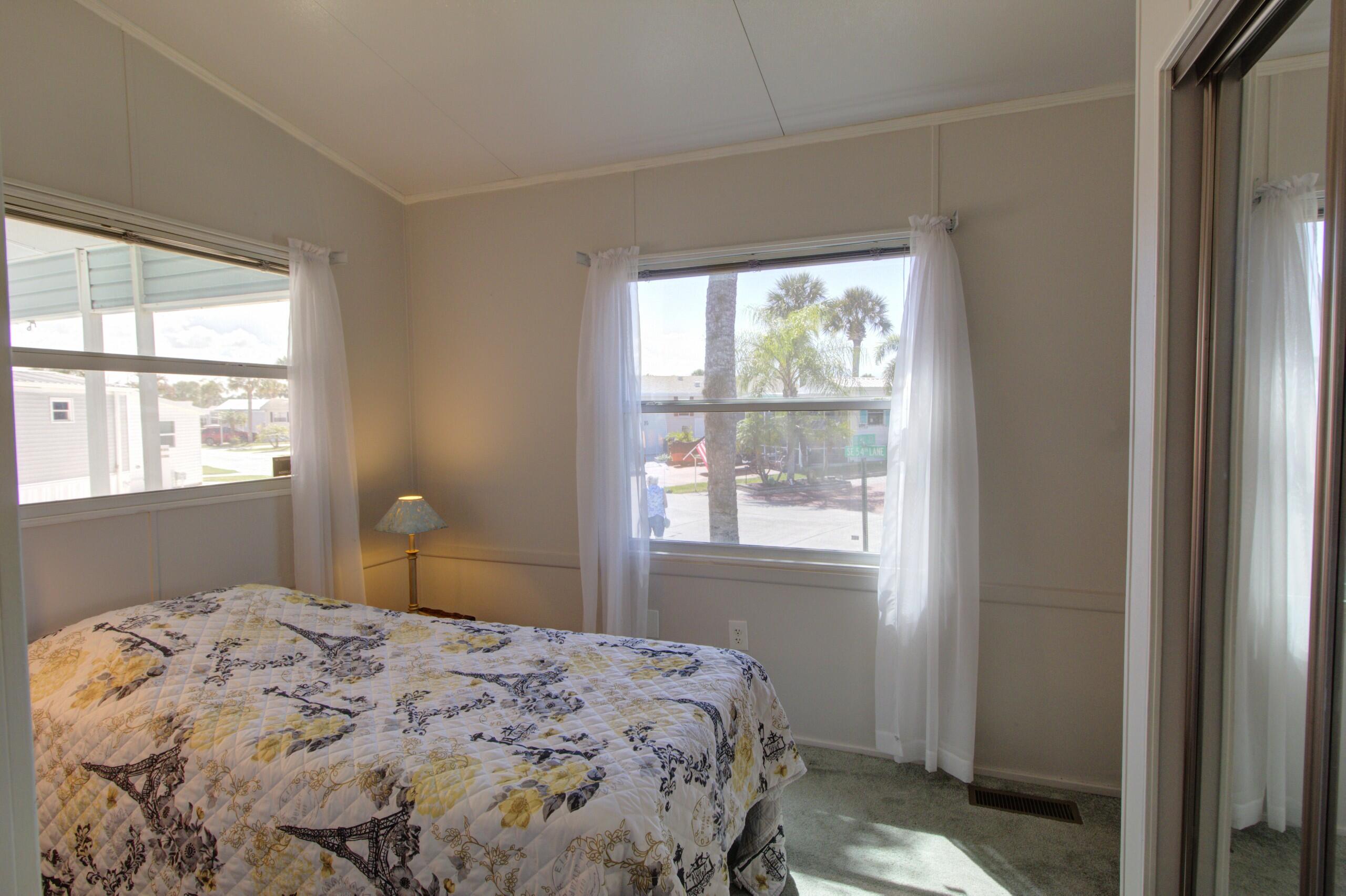 5395 Southeast 64th Terrace Okeechobee, FL 34974 - Photo 16 of 24 a bedroom with a bed and a window