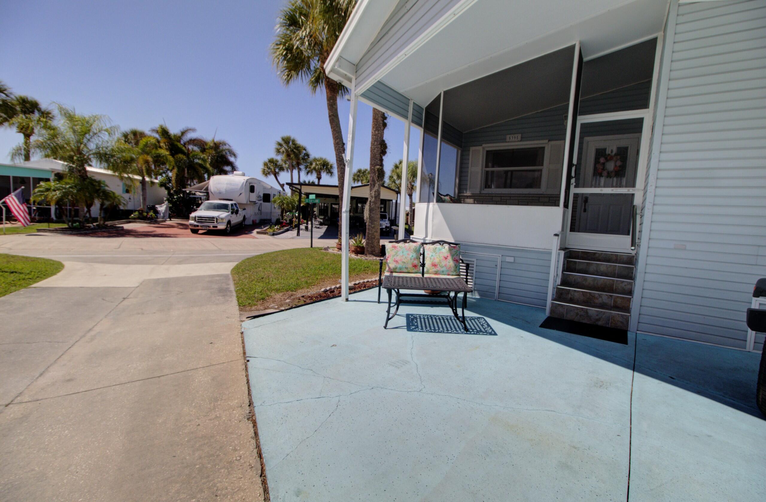 5395 Southeast 64th Terrace Okeechobee, FL 34974 - Photo 22 of 24 a view of a patio with chairs and potted plants