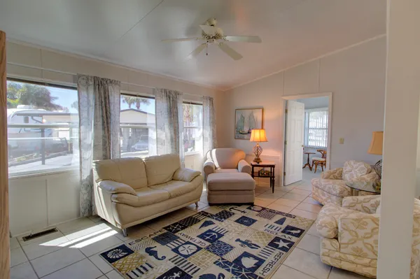 a living room with furniture a rug and a chandelier
