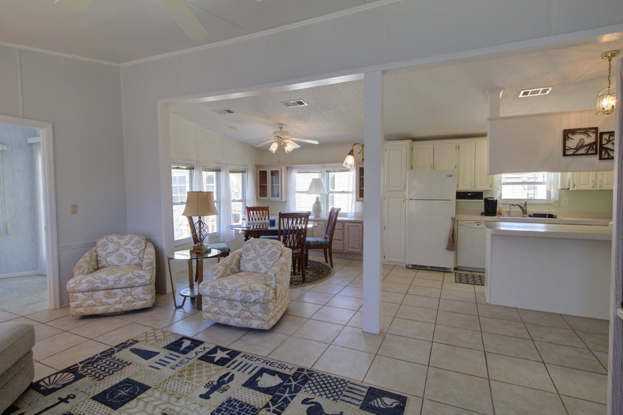 5395 Southeast 64th Terrace Okeechobee, FL 34974 - Photo 6 of 24 a living room with furniture and kitchen view
