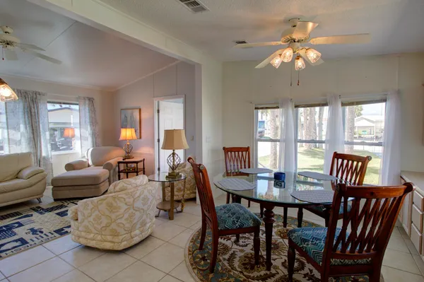 a view of a dining room with furniture wooden floor and chandelier