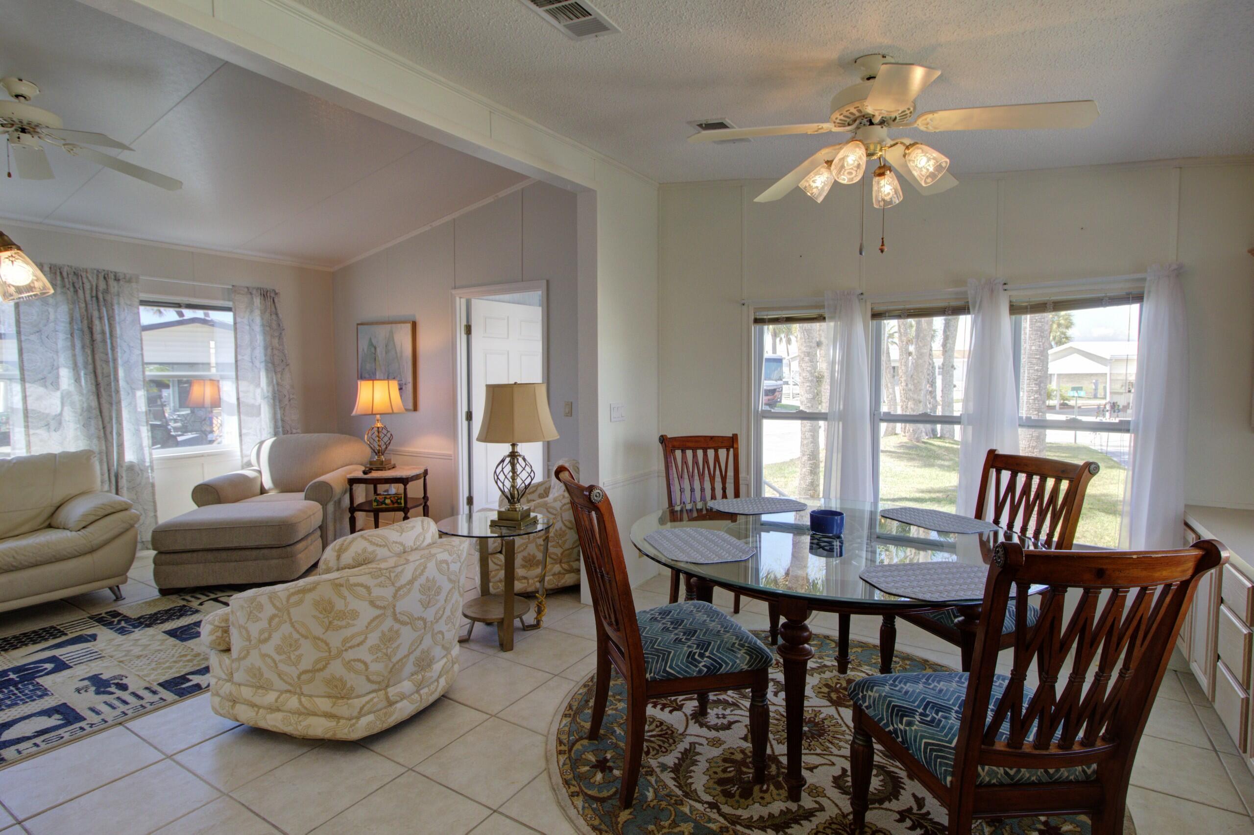 5395 Southeast 64th Terrace Okeechobee, FL 34974 - Photo 8 of 24 a view of a dining room with furniture wooden floor and chandelier